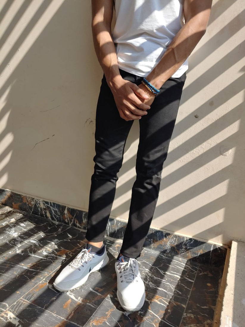 Men’s black skinny fit jeans with stretch fabric and tapered ankle design