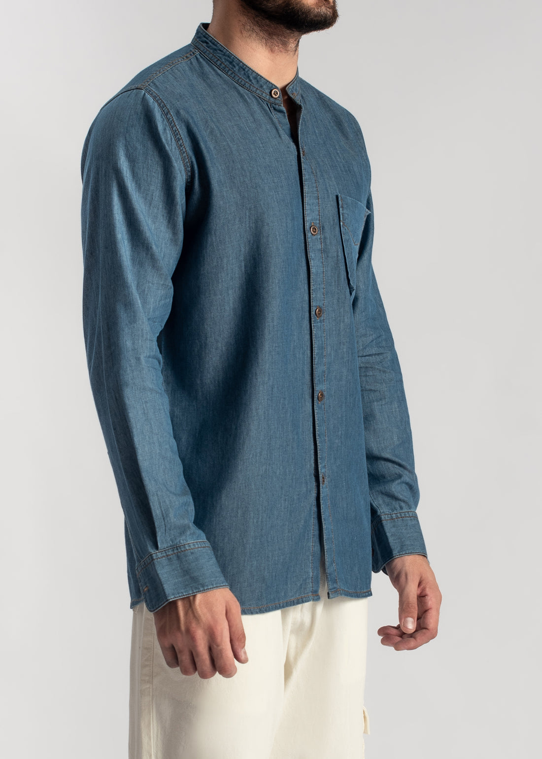Men's blue denim band collar shirt with relaxed fit and casual styling
