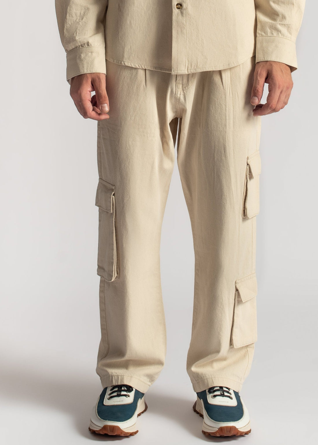 Men’s relaxed fit beige cargo pants with oversized utility pocket detailing
