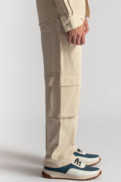 Men’s relaxed fit beige cargo pants with oversized utility pocket detailing