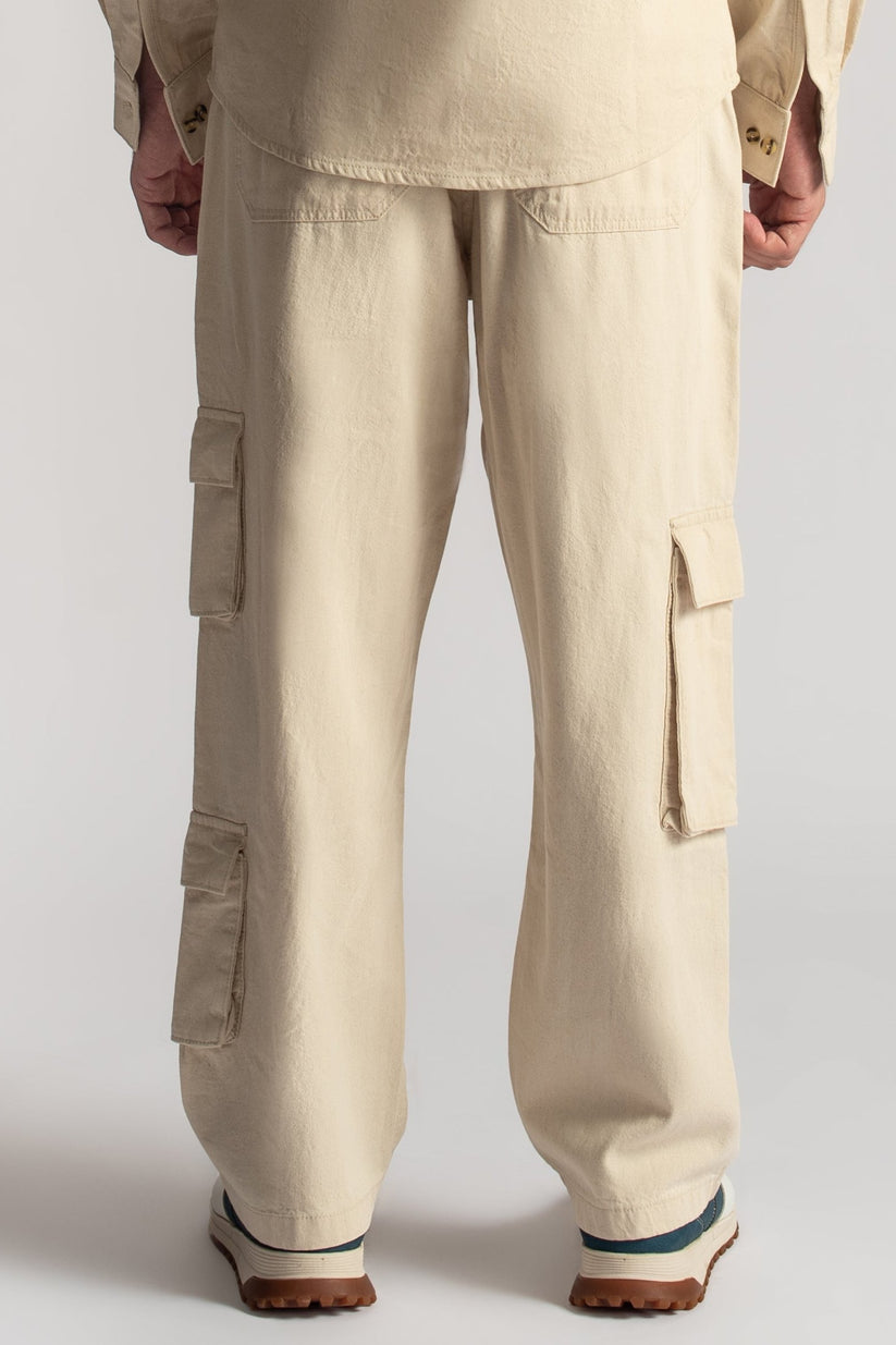 Men’s relaxed fit beige cargo pants with oversized utility pocket detailing