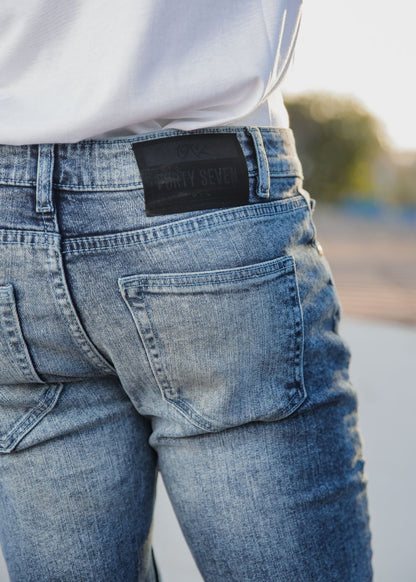 Men’s slim fit acid wash blue jeans with distressed vintage finish
