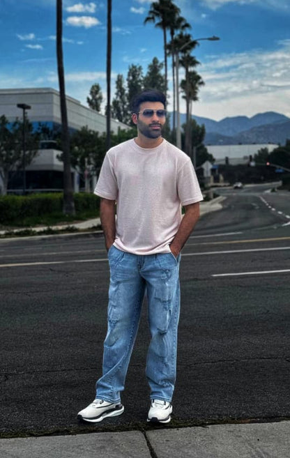 Men's slim fit blue ripped jeans with distressed knee detailing