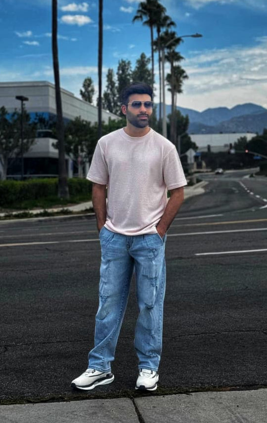 Men's slim fit blue ripped jeans with distressed knee detailing