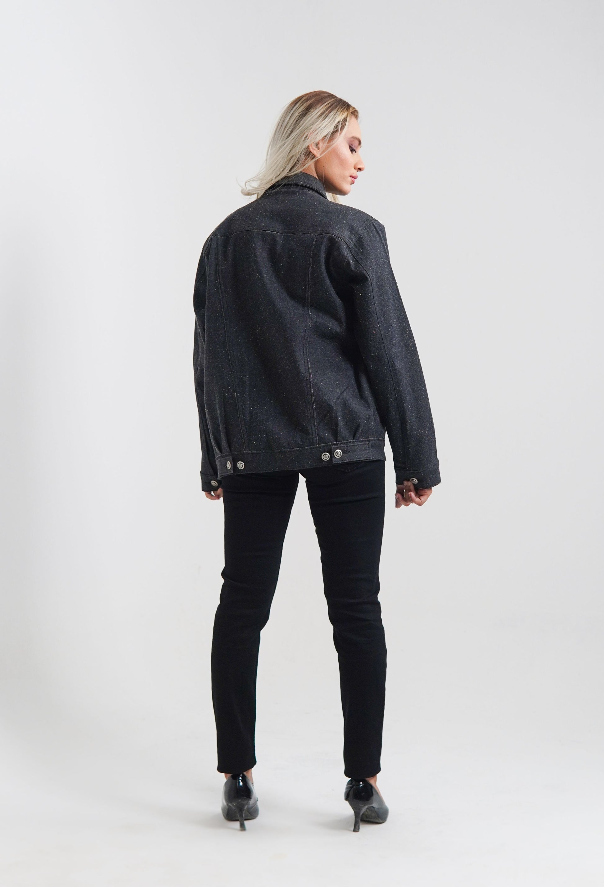 women's black denim jacket with a collared neckline and button details