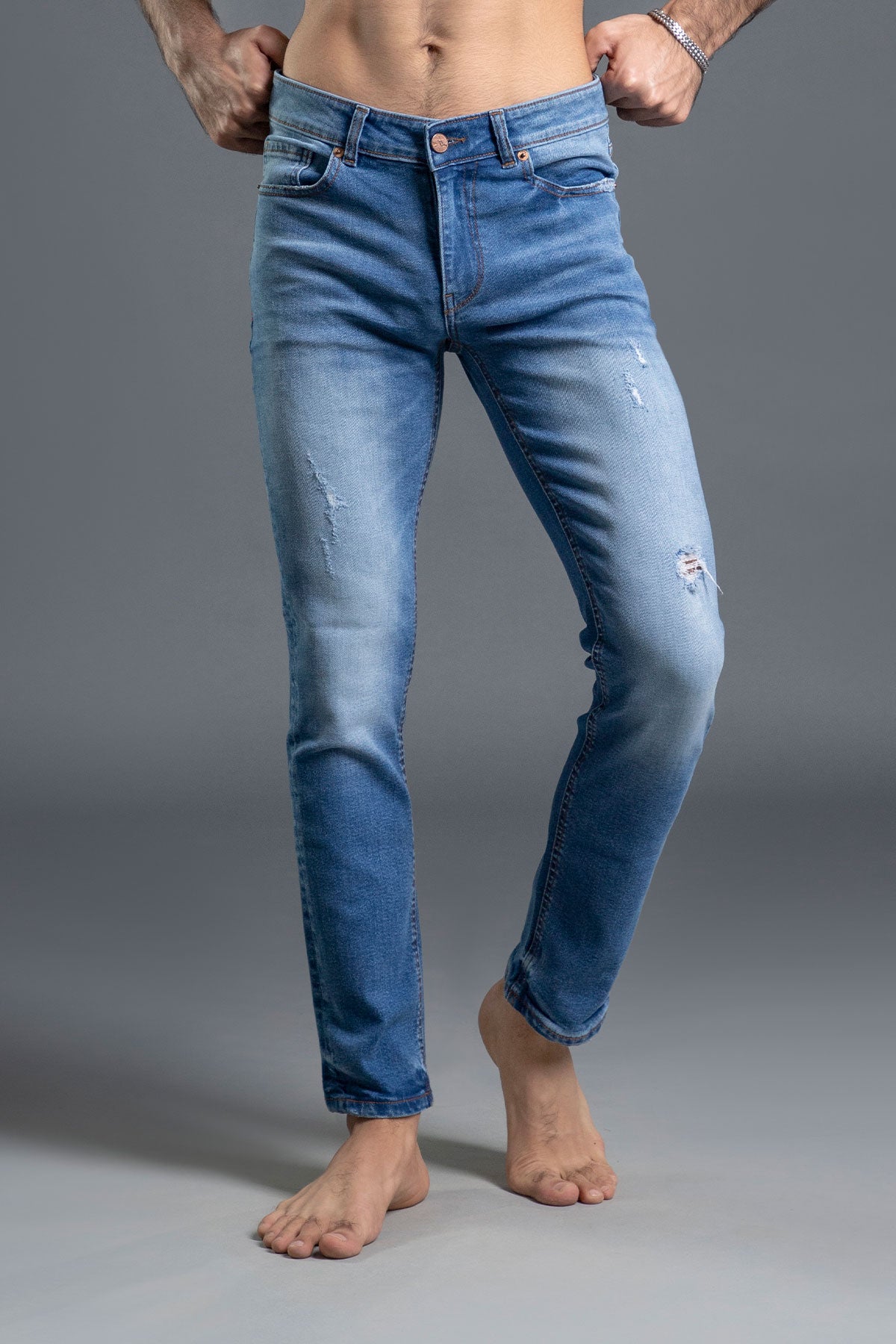 Men's light blue ripped and repaired skinny jeans