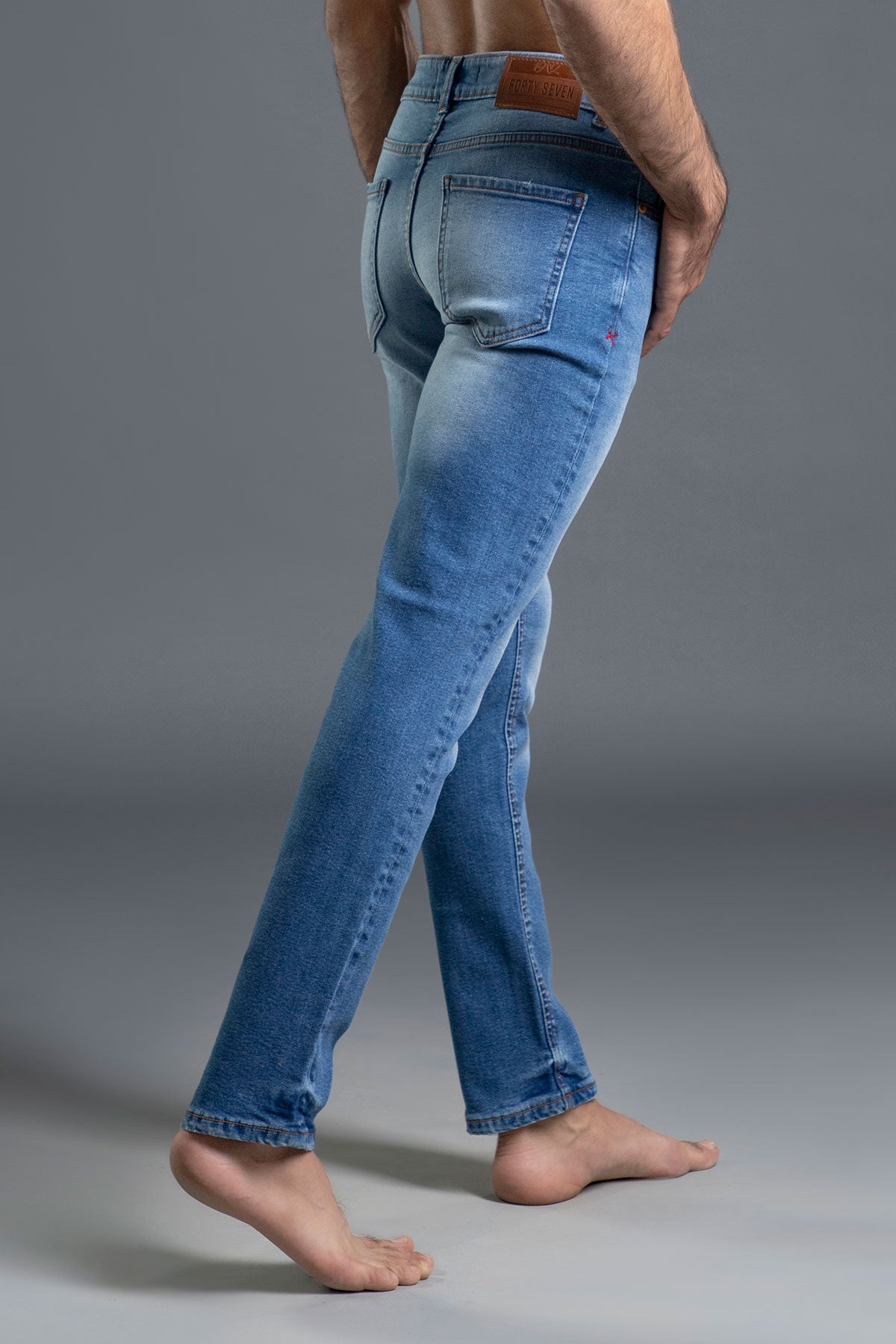 Men's light blue ripped and repaired skinny jeans