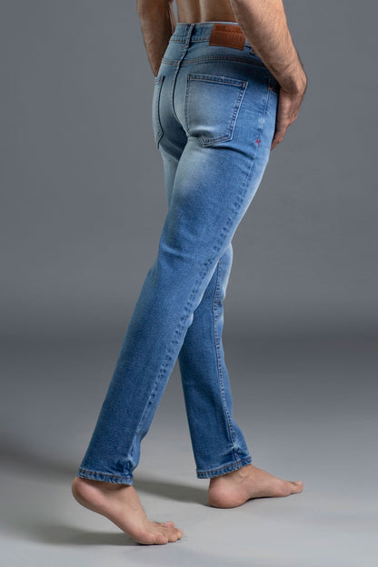Men's light blue ripped and repaired skinny jeans