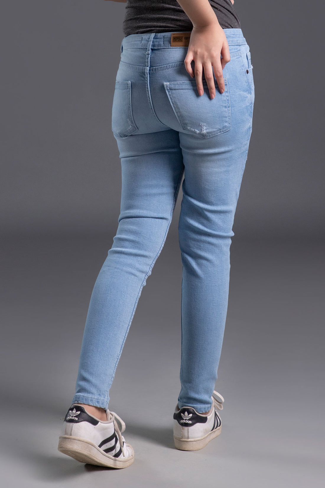 Women's Skinny Ripped Jeans in Light Blue Wash Featuring a Zipper Fly and Handmade Ripped and Repaired Abrasions