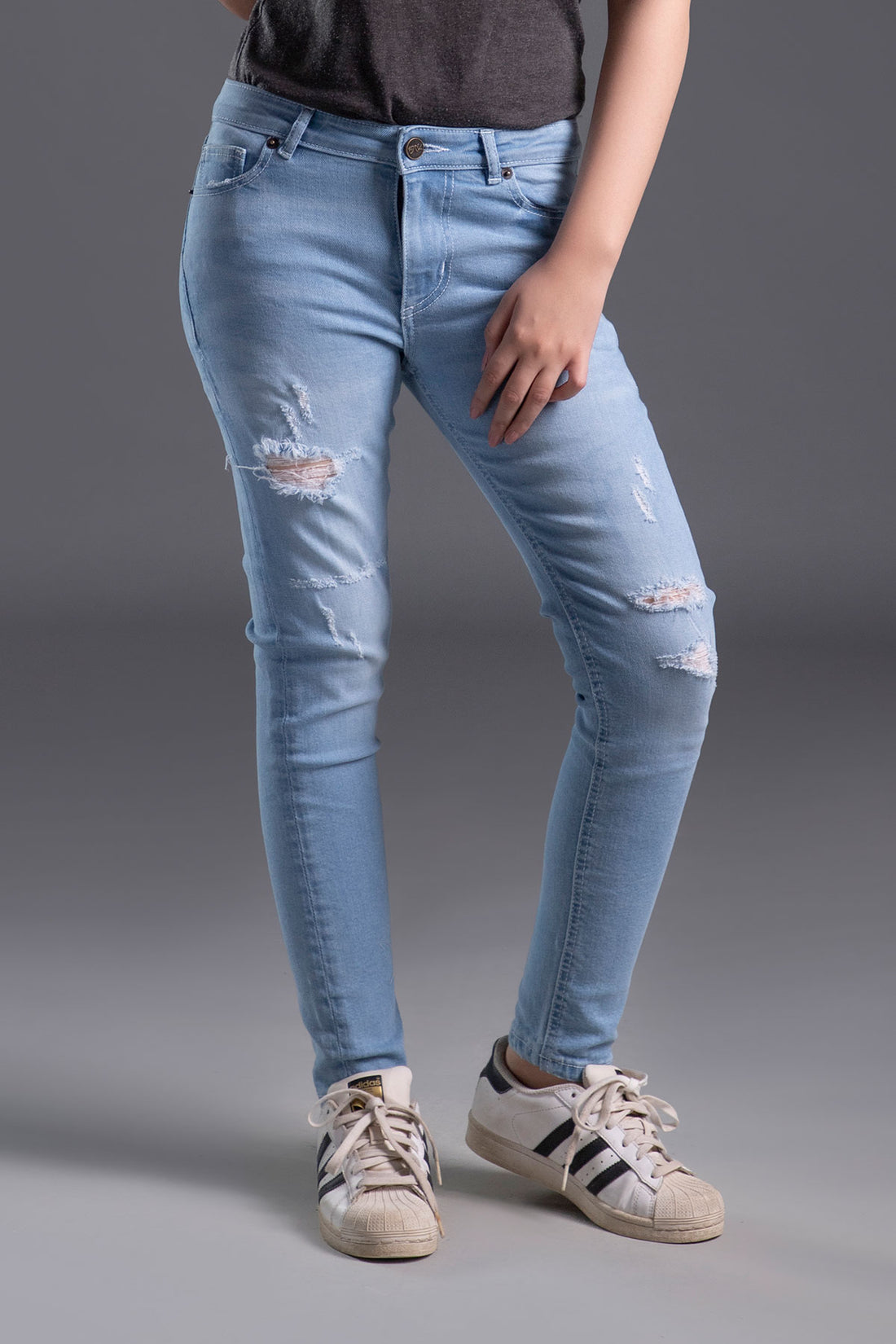 Women's Skinny Ripped Jeans in Light Blue Wash Featuring a Zipper Fly and Handmade Ripped and Repaired Abrasions