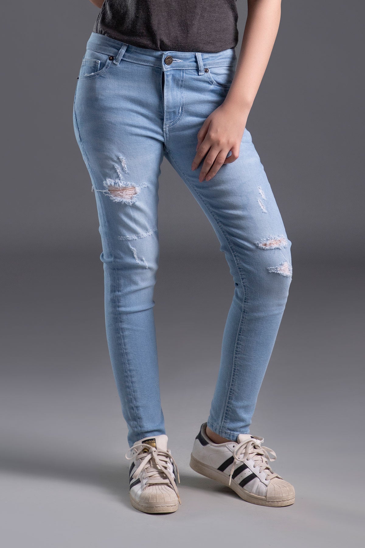 Women's Skinny Ripped Jeans in Light Blue Wash Featuring a Zipper Fly and Handmade Ripped and Repaired Abrasions
