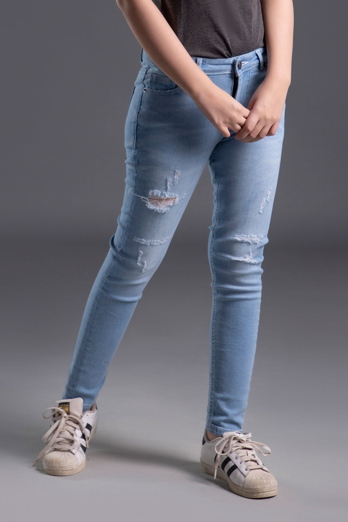 Women's Skinny Ripped Jeans in Light Blue Wash Featuring a Zipper Fly and Handmade Ripped and Repaired Abrasions