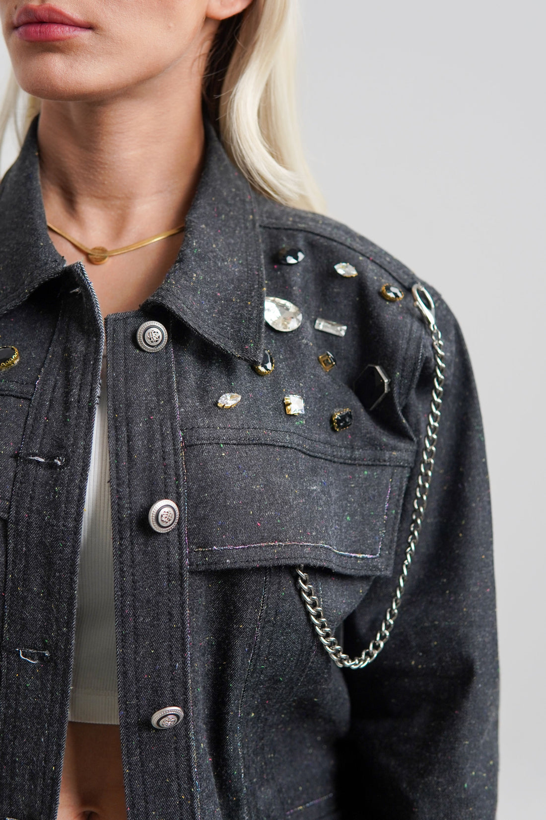 women's black denim jacket with a collared neckline and button details