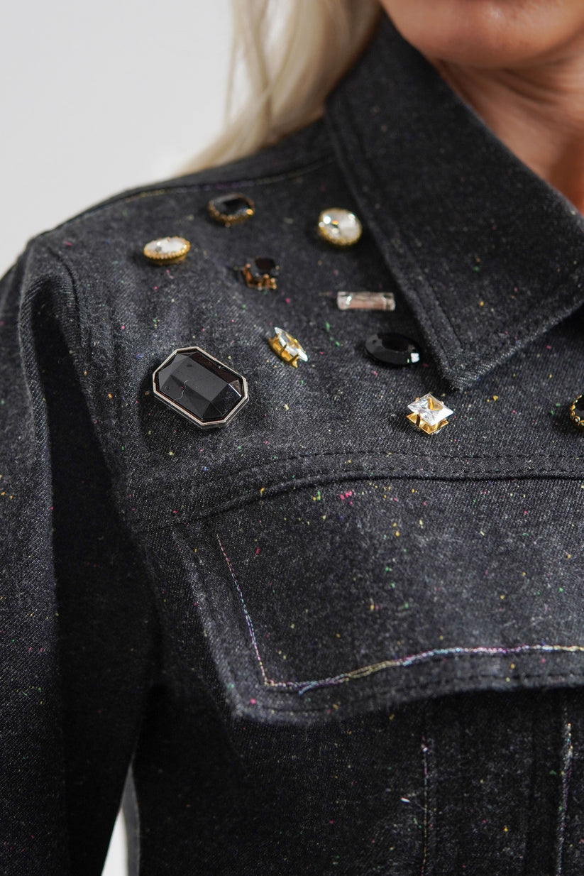 women's black denim jacket with a collared neckline and button details