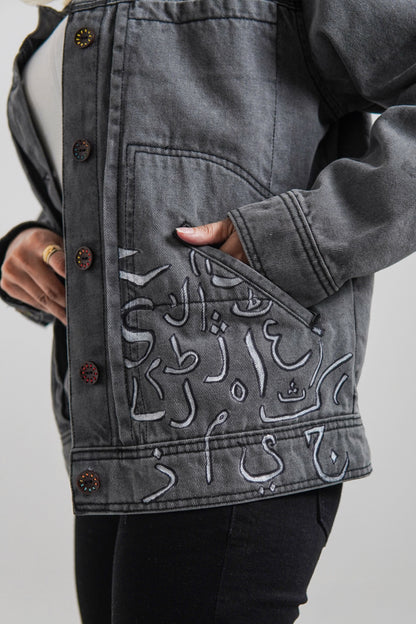 Women's denim jacket in grey with a slogan on the front and back