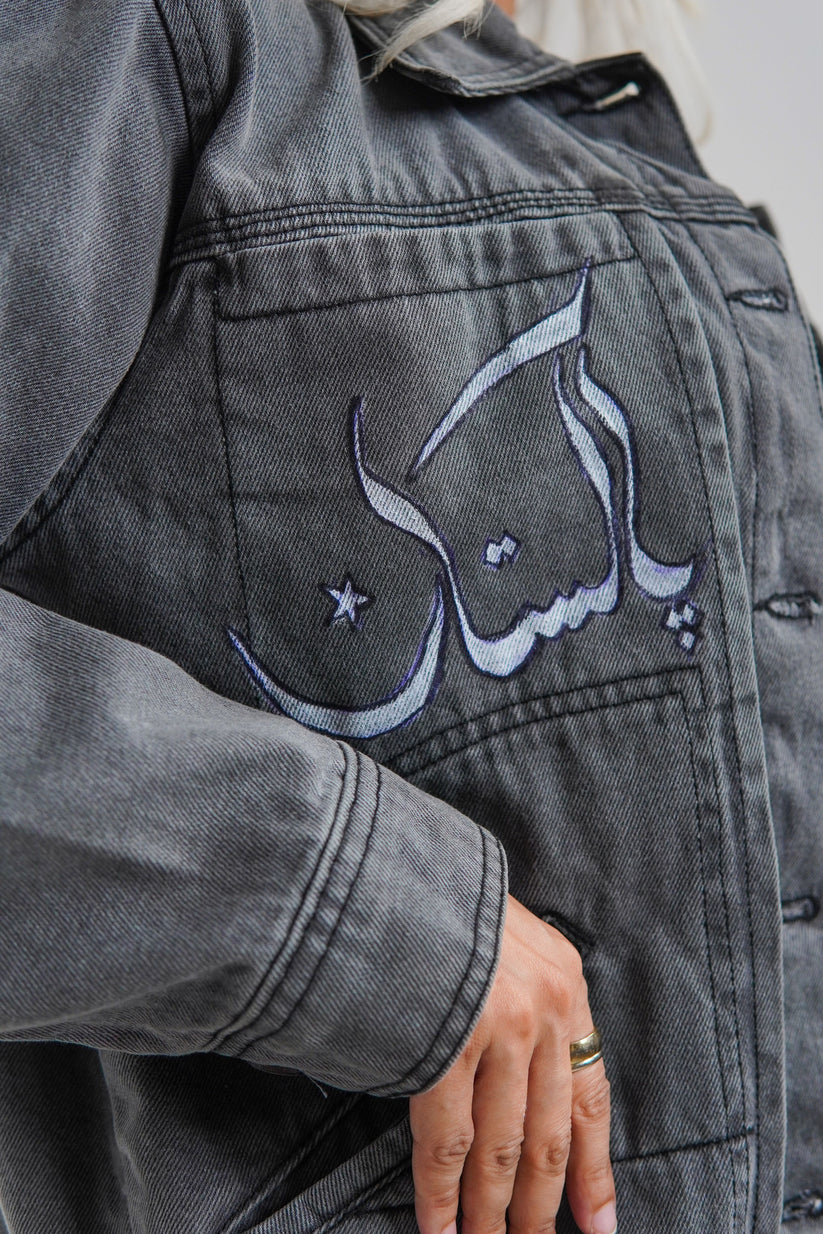 Women's denim jacket in grey with a slogan on the front